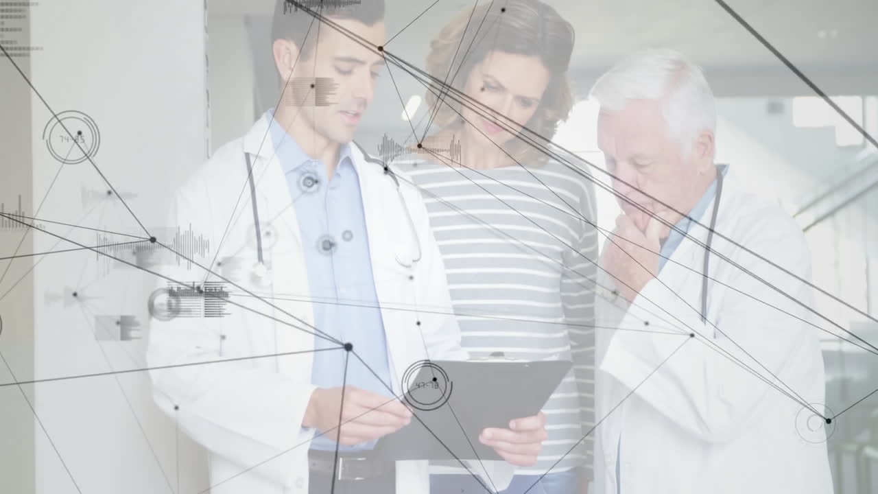Doctors and patient using tablet in clinic corridor, displaying health data graphics