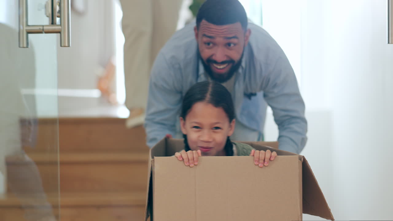 Happy family, moving in new home playing with box