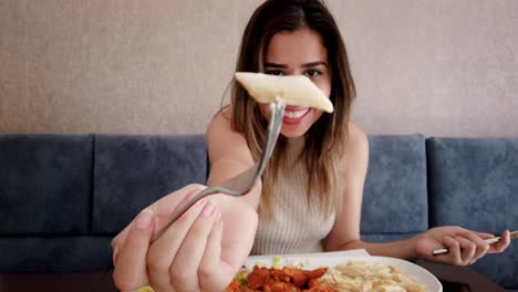 Slow-motion:Beautiful-young-girl-eats-chicken-food-with-a-big-enjoy-in-a-restaurant-or-cafe-while-sitting