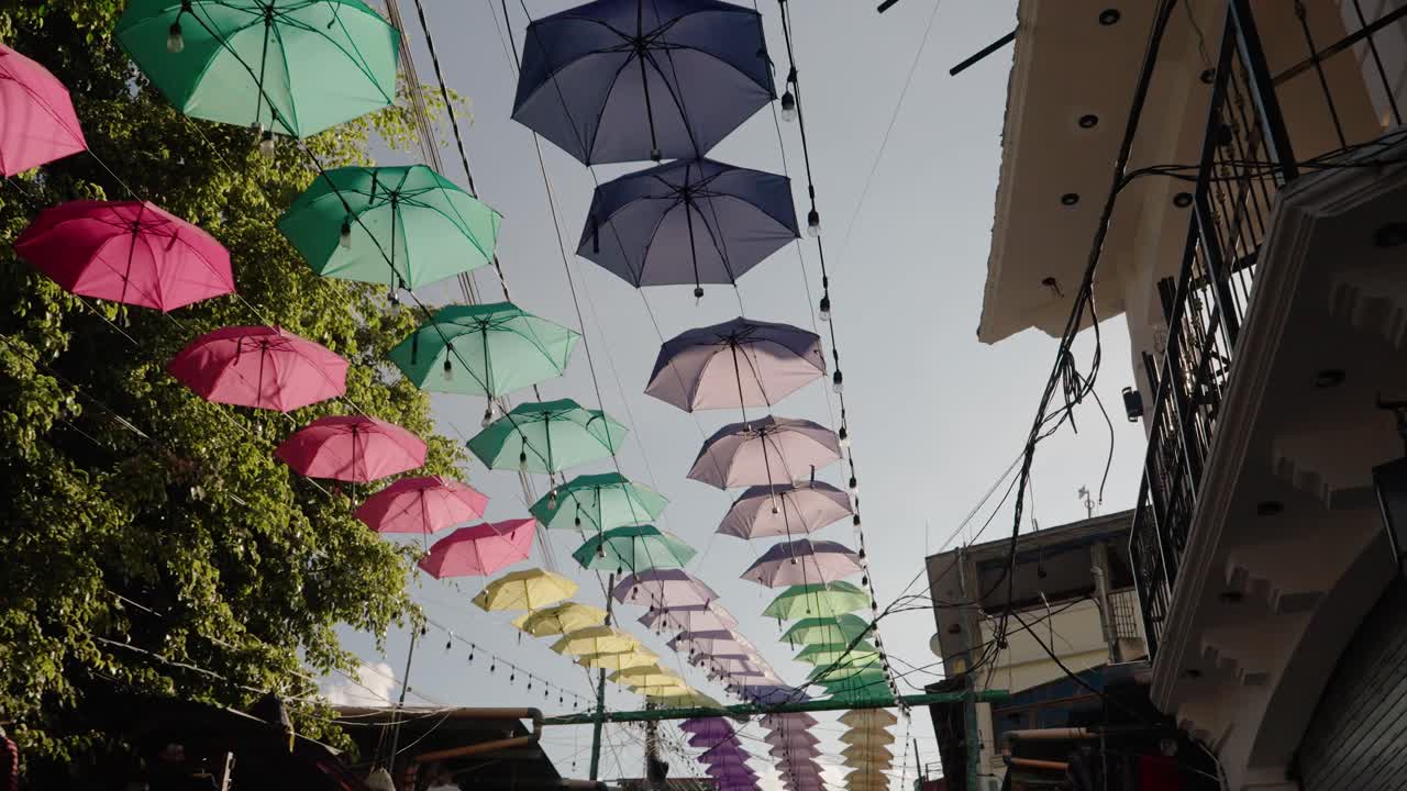 Ombrelli colorati sospesi sopra una strada a San Juan La Laguna, Guatemala
