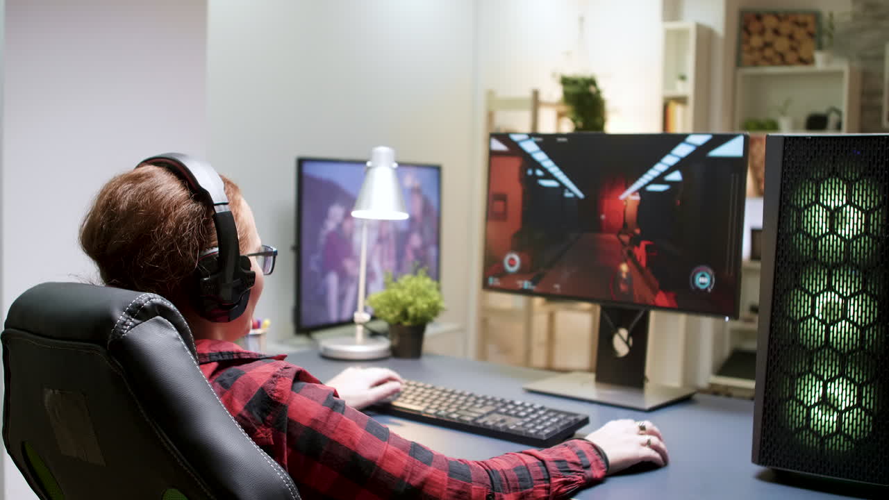 Woman playing video games at her desk