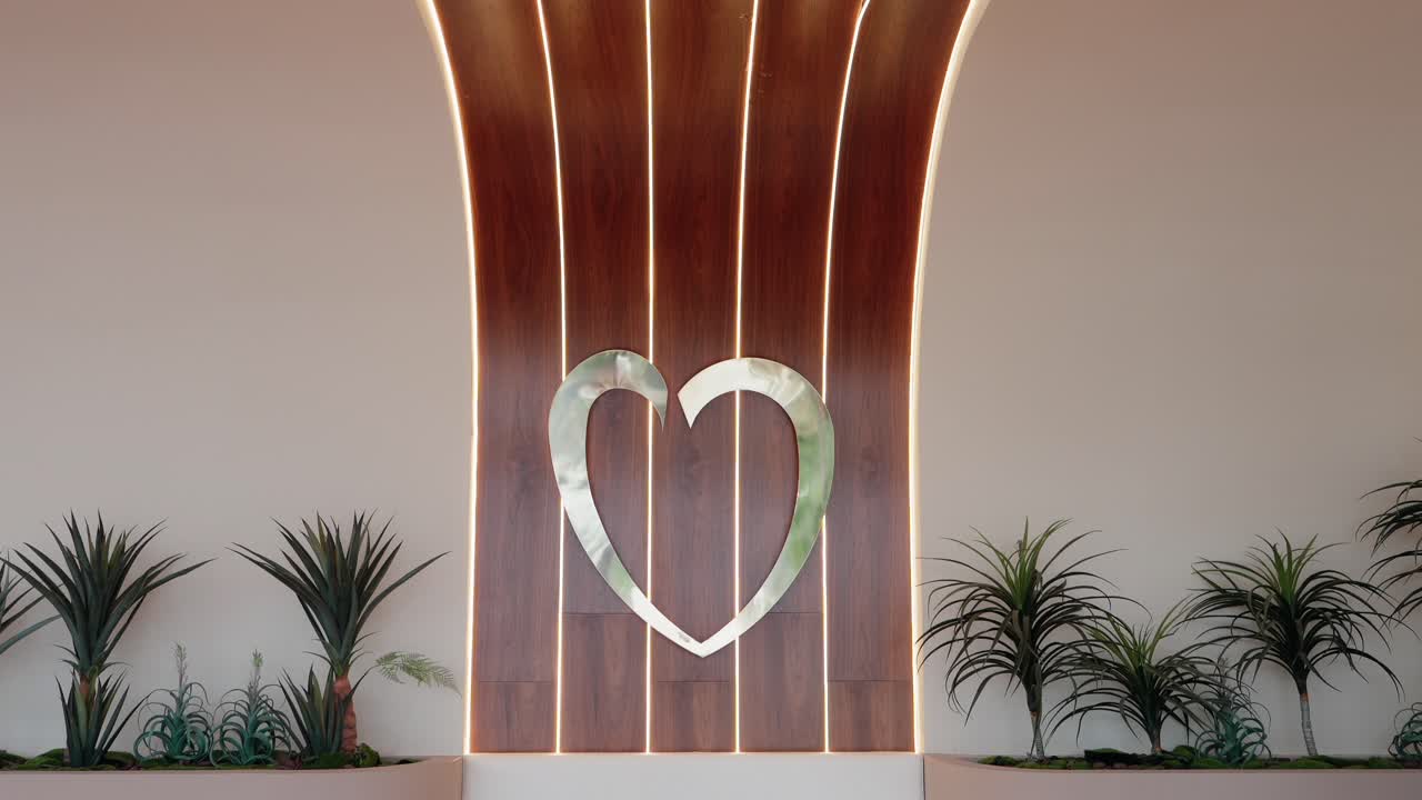 modern wood wall with glowing heart symbol and tropical plants in minimalist space
