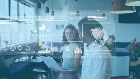 Animation-of-graphs,-globes-and-loading-bars-over-diverse-coworkers-discussing-reports-in-office