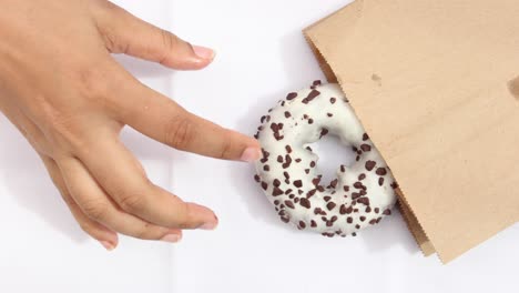 Close-up-of-hand-holding-donuts