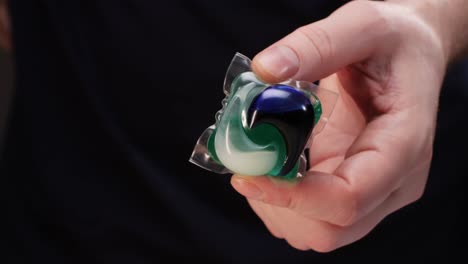 person holding a laundry pod