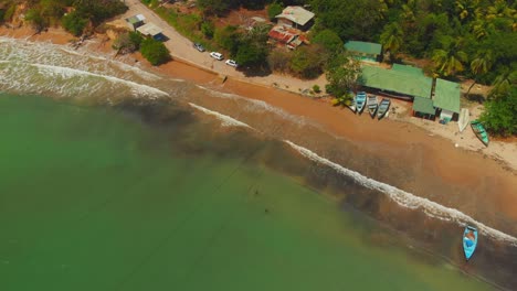 Fischerboote-Im-Wasser-Und-Wellen,-Die-An-Dieser-Epischen-Nordküstenküste-In-Balnadra-Bay-Auf-Der-Karibischen-Insel-Trinidad-Und-Tobago-Zusammenbrechen