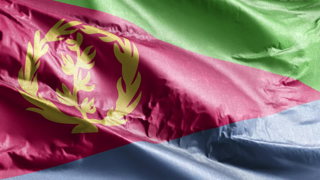 bandera textil de eritrea ondeando en el bucle del viento. estandarte eritreo balanceándose en la brisa. tejido textil de tela. fondo de relleno completo. bucle de 10 segundos.