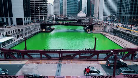 timelapse of white caucasian male wearing red jacket on bridge during saint patricks day in chicago