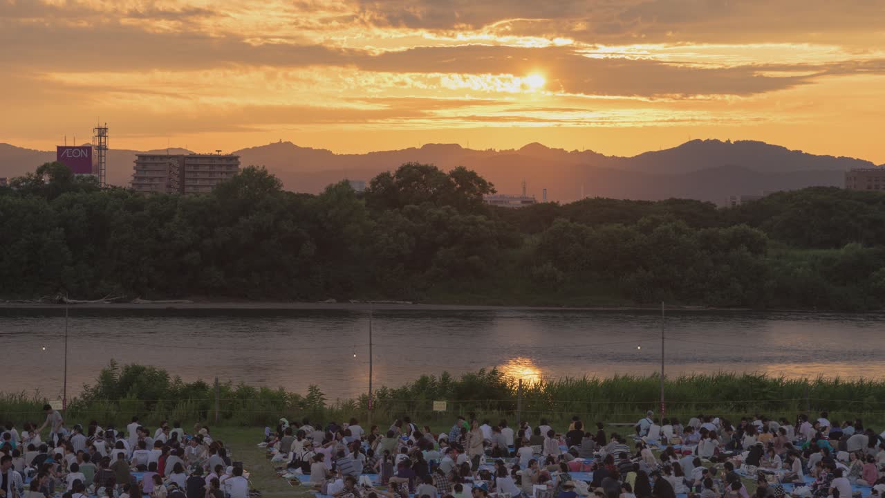 Sunset River View with Large Crowd
