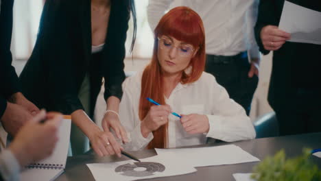 businesswoman discussing strategy with employees in office.