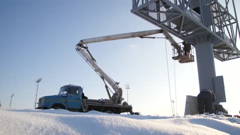 maintenance work on a billboard in winter