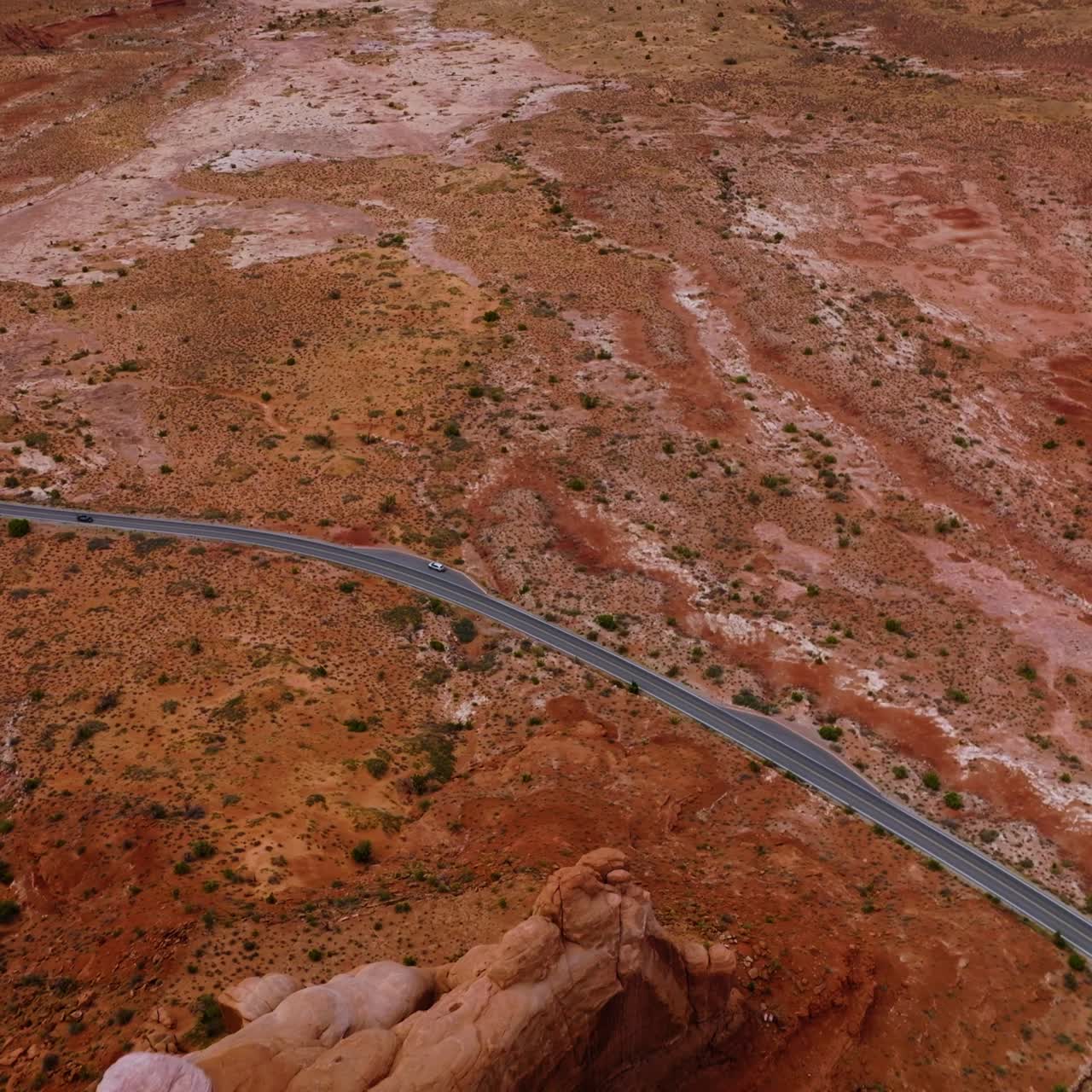Flying over the canyon and plain in the national park of America. Speed highway going along the flat among the beautiful rocks. Top view