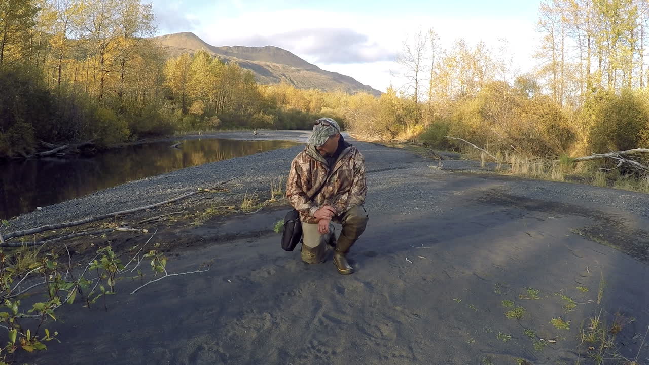 An Alaska wilderness guide identifies the large tracks of a Kodiak brown grizzly bear on Kodiak Island Alaska