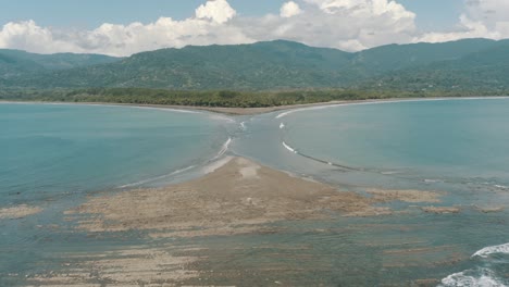 Drone-aerial-view-of-whale-tail-beach-and-beautiful-landscape-of-Marino-Ballena-National-Park-in-Uvita,-Costa-Rica