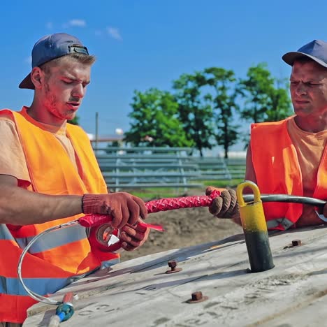 engineers on the solar farm construction. workers build new ecological power station on the field. men technician working with pipes for clean energy.