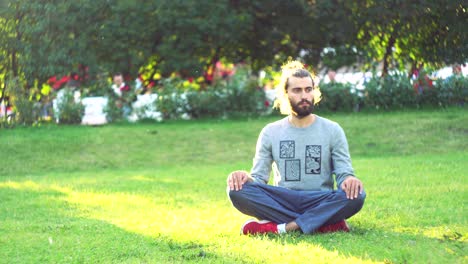 man meditating in a park