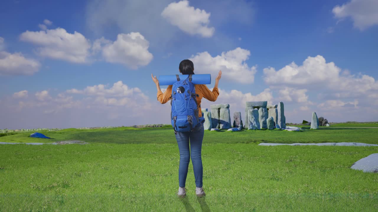 Full Body Back View Of A Female Hiker With Mountaineering Backpack Spreading Arms And Looking The View Around While Traveling In Stonehenge