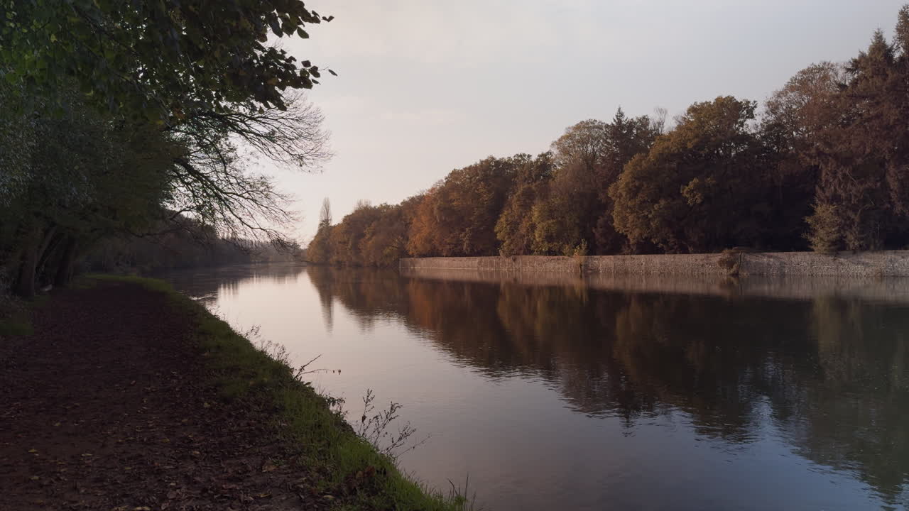Static view of the tree-lined Cher River in France’s Loire Valley at dusk