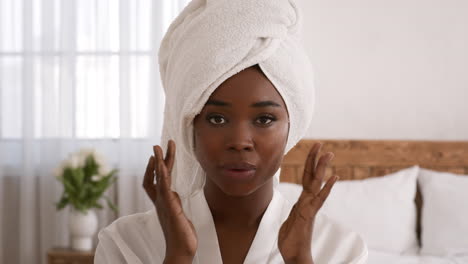 woman applying face mask or cream