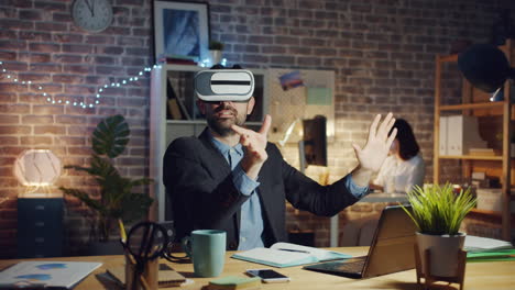 businessman using vr headset in office at night
