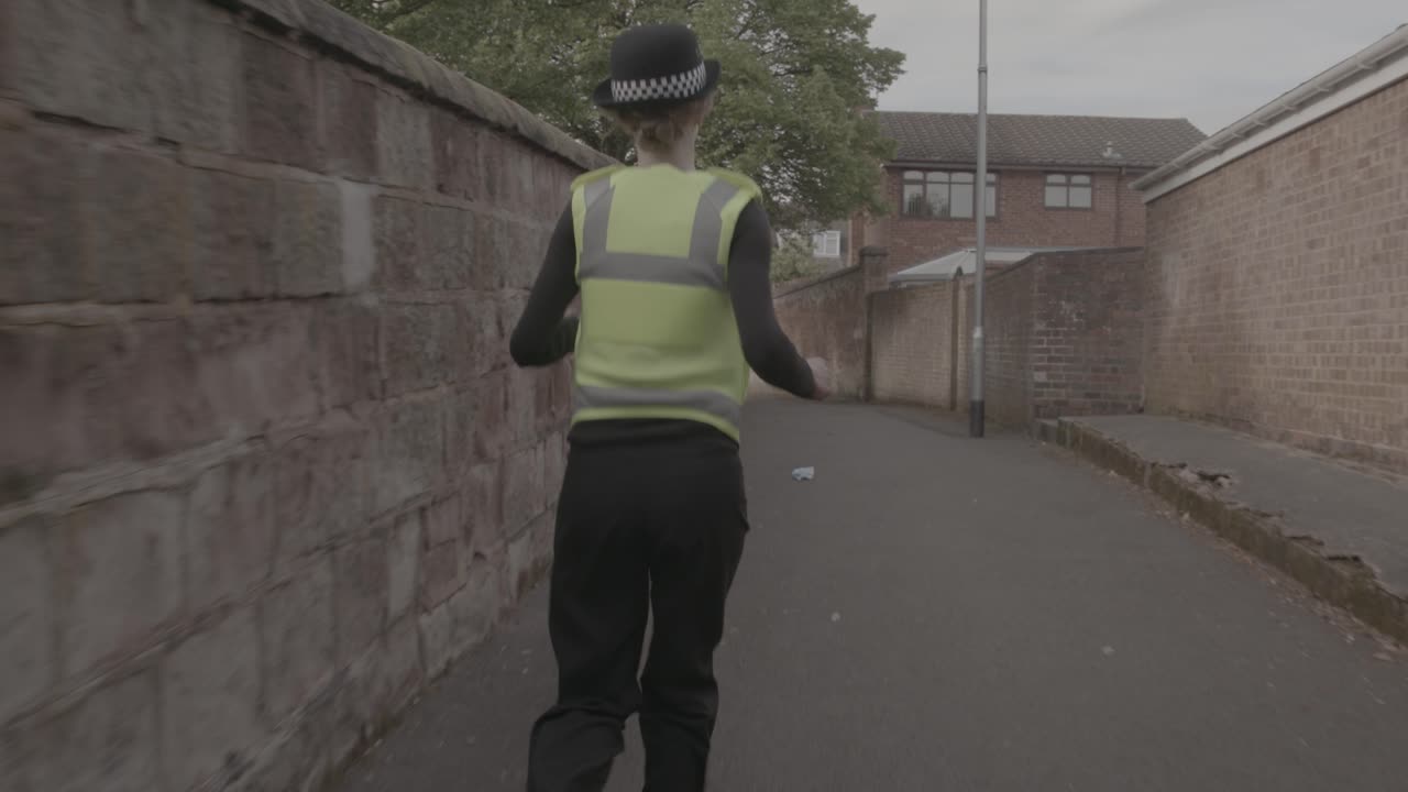 Police Officer Running Through Alleyway