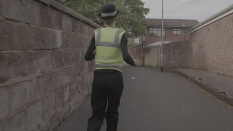 police officer running through alleyway