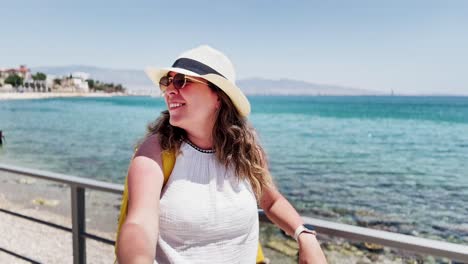 happy tourist vlogging on greek seaside promenade