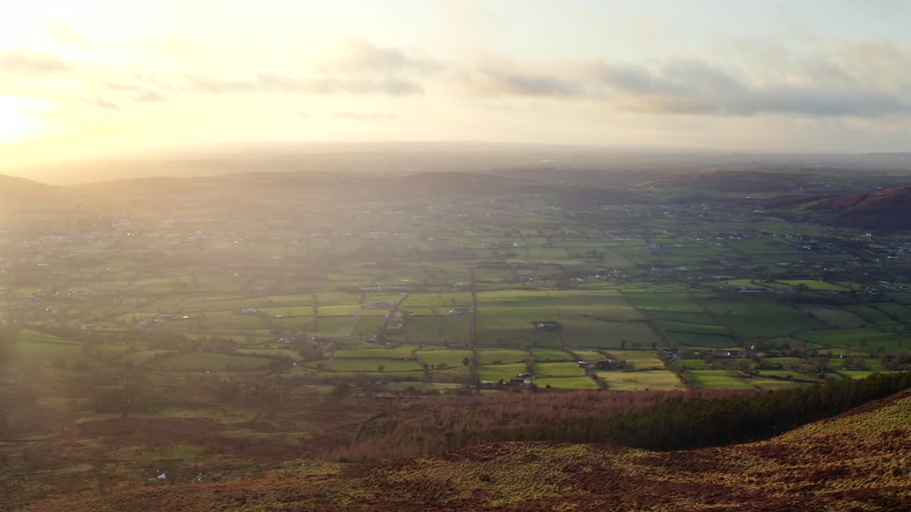 Wintery sunset at Ring of Gullion, Newry, Northern Ireland. December 2019. Drone slowly tracks across Slieve Gullion facing West towards Mullaghbane and gradually panning North.