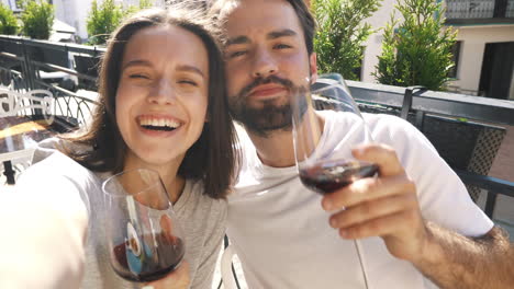 couple enjoying wine at an outdoor cafe