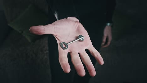 key hidden in the fist of male hand