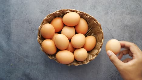 hand pick eggs from a plastic case on table ,