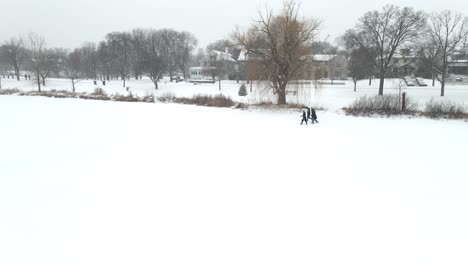 Drei-Personen,-Die-Während-Eines-Schneewintersturms-Im-Park-Spazieren