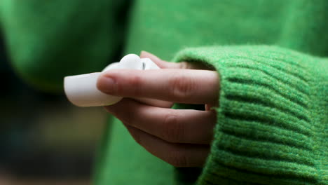 young woman holding earpods case