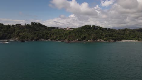 Drone-view-speeding-from-the-ocean-towards-a-luxury-property