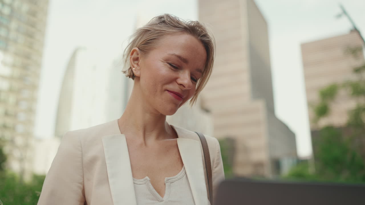 Businesswoman using laptop in the city