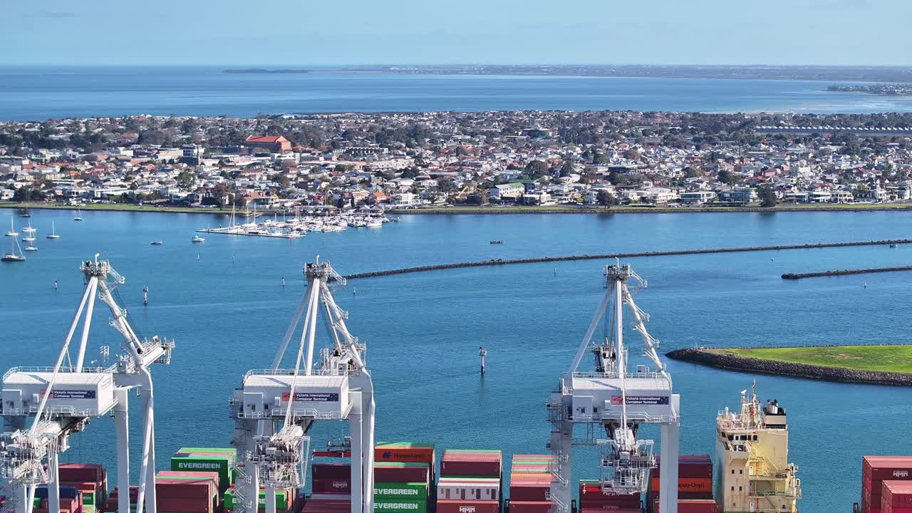 Shipping cranes operate at Melbourne Webb Dock East to load containers