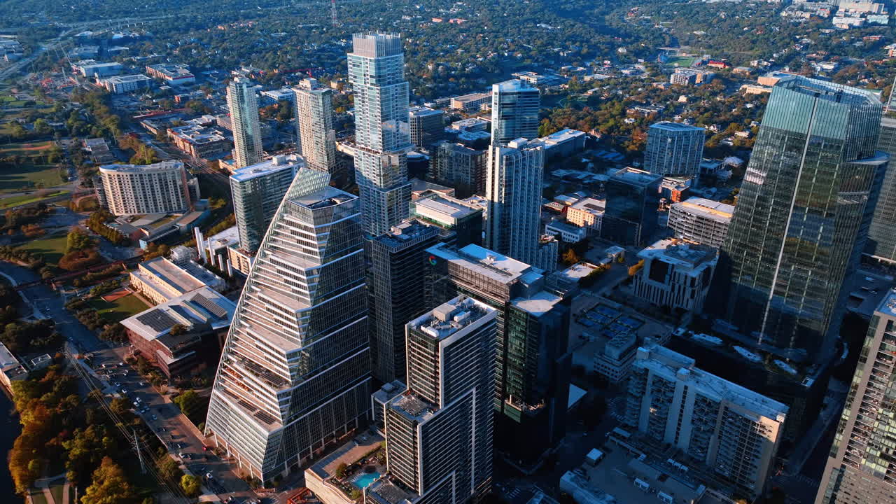 Austin, USA, 21 November 2025: Flight over the high-rise downtown of Austin, Texas, USA. Low-rise green cityscape at backdrop