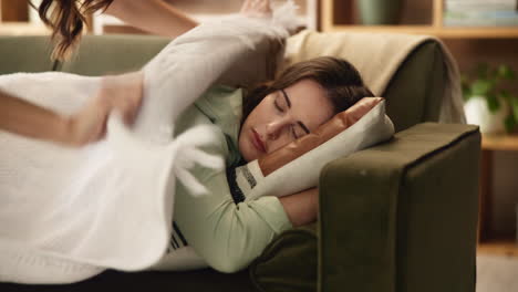 woman sleeping comfortably on a sofa