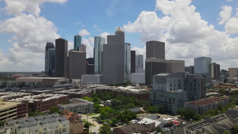 Aerial-of-Houston-downtown-skyline-at-noon,-tilt-up-reveal