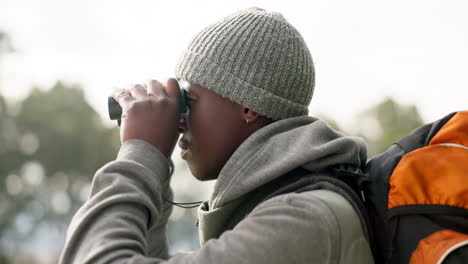 black man, binoculars and backpack in travel