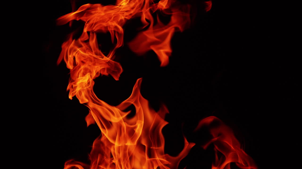 Red blaze upper part view. Campfire burning isolated in the darkness. Close up.