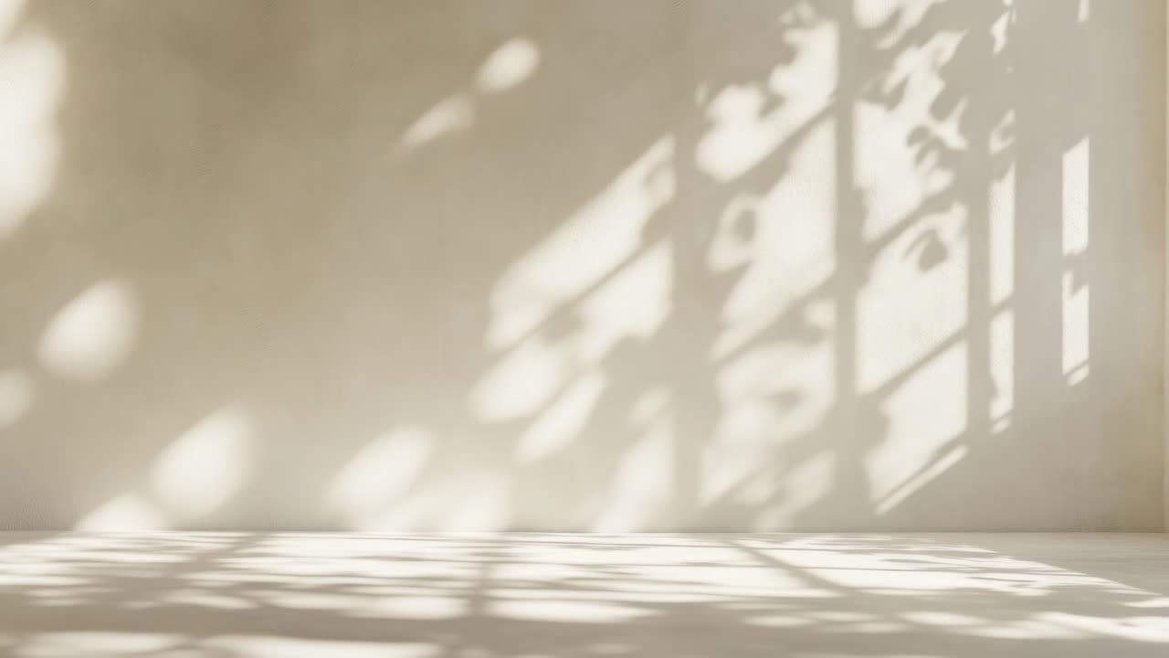 Minimalist video backdrop with soft shadows of leaves on a beige wall
