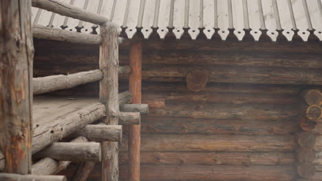 medieval log house and wooden fence with stairs and platform