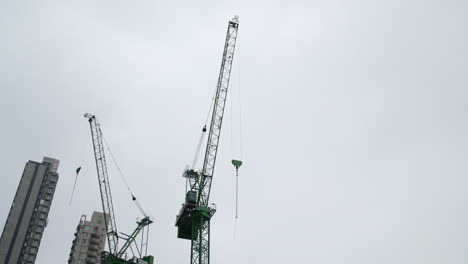 crane carries heavy load swinging large arm through hong kong city