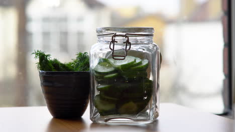 filling glass jar with fresh vegetables for marinade cooking