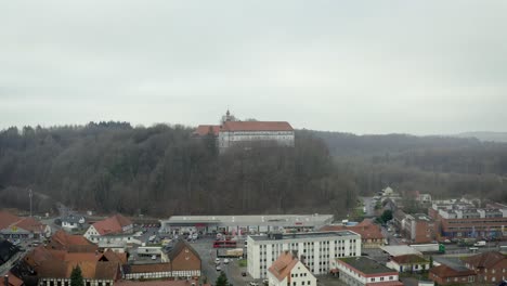 drone aerial view of the traditional german village herzberg am harz in the famous national park in central germany on a cloudy day in winter.