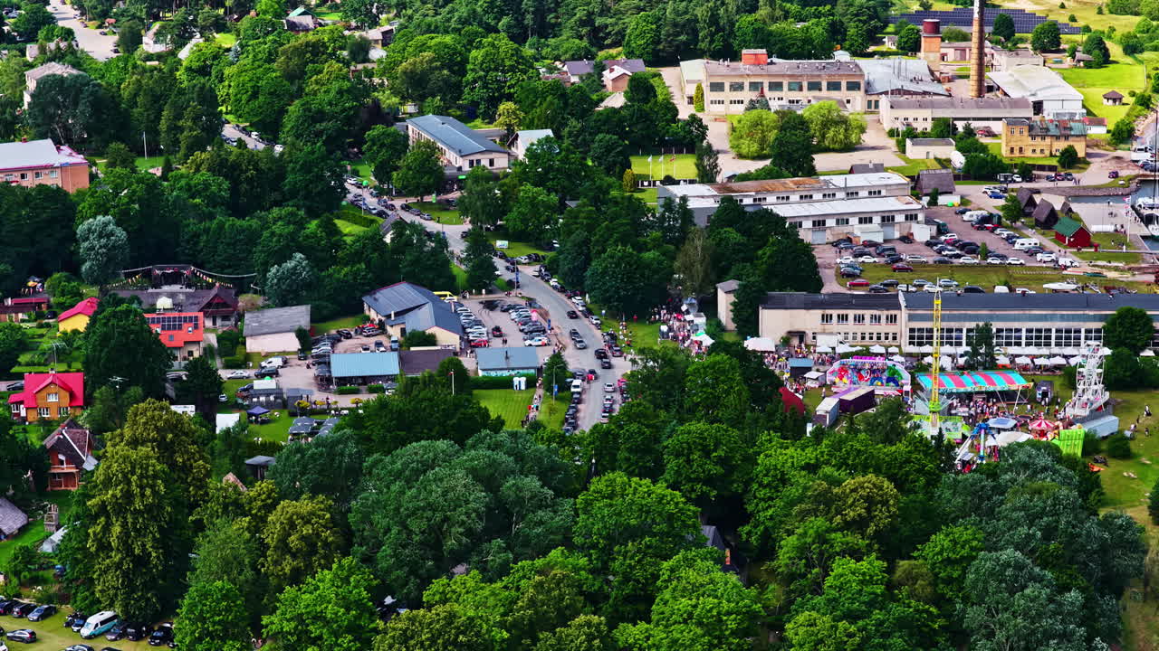 Overhead drone pullback of festive gathering and colorful stalls in Latvia
