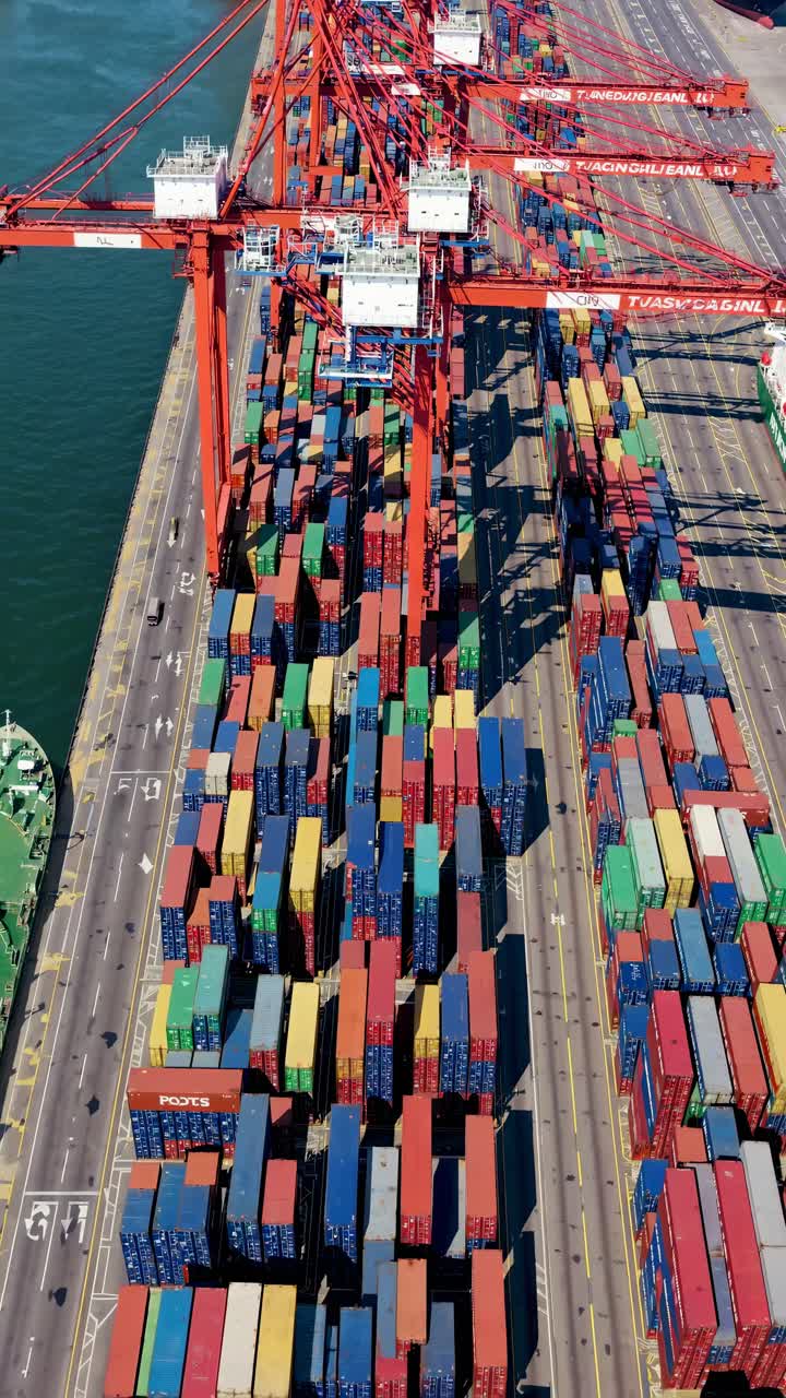 Aerial view of a bustling port with colorful shipping containers and cranes