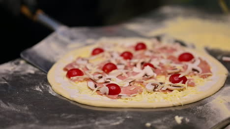 chef is cooking pizza. restaurant chef in kitchen cooks traditional italian pizza