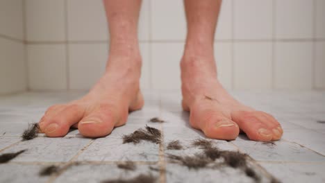 dark hair falling in front of a man's feet